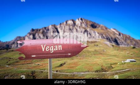 An image with a signpost in German pointing in the direction of Vegan. Stock Photo