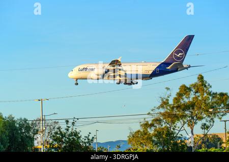 Los Angeles, California - January 12, 2026: Lufthansa Airbus A380 descends with landing gear extended against a clear blue sky, preparing to land at L Stock Photo