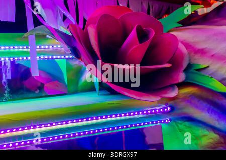 Colorful Neon Rose Decoration With LED Lights on Festive Party Float Display Stock Photo