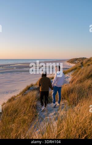 Couple enjoys a sunset stroll on the scenic beaches of Denmark Stock Photo