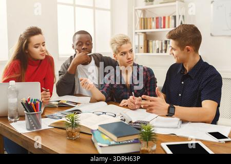Group of Students Working Together on a Project in a Study Space During Daytime Hours Stock Photo