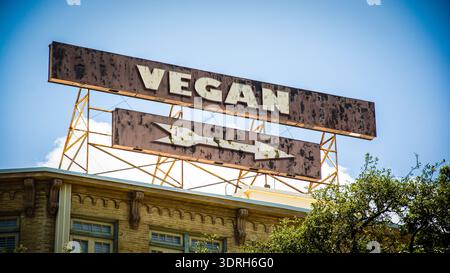 An image with a signpost in German pointing in the direction of Vegan. Stock Photo