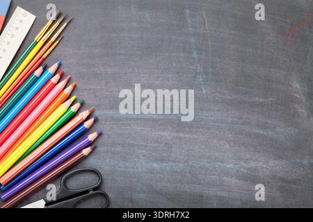 School supplies on blackboard background Stock Photo