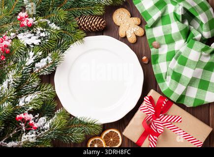 Christmas tree branch, empty plate and coffee. Top view with copy space Stock Photo
