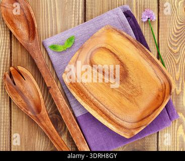 Wooden kitchen utensils over wood table Stock Photo