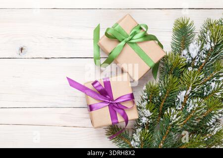 Christmas fir tree with snow and gift boxes Stock Photo