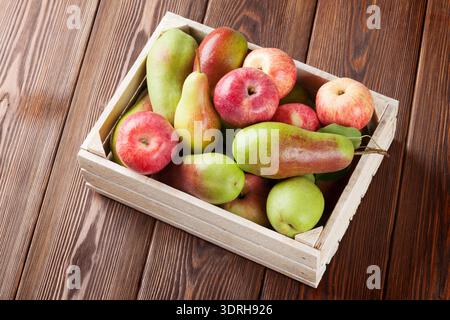 Pears and apples in wooden box Stock Photo