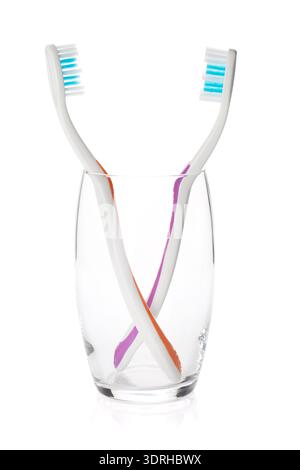 Two toothbrushes in a glass. Isolated on white background Stock Photo