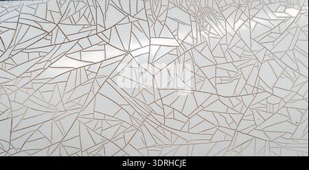 Cracked and peeling white plastic surface with intricate fracture patterns Stock Photo