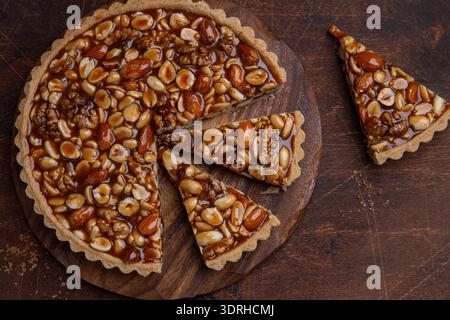 Caramel and nuts tart, sweet and tasty cake, top view, copy space Stock Photo