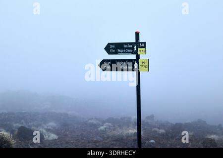 teide hiking route trail direction signs in misty low cloud cover weather tenerife canary islands spain Stock Photo