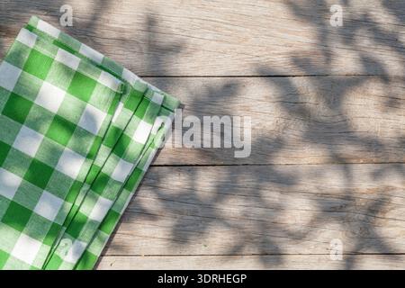 Empty wooden garden table with tablecloth Stock Photo