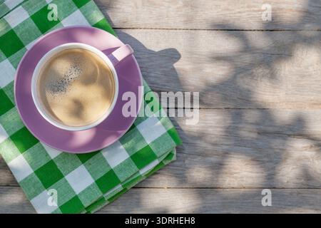 Coffee cup on garden table Stock Photo