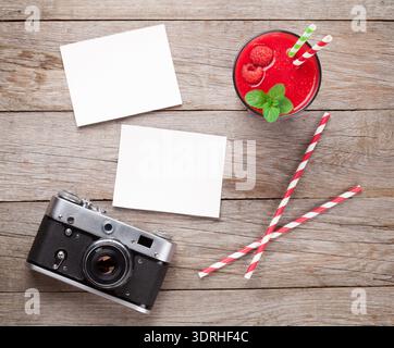 Vintage camera, two photos and raspberry smoothie Stock Photo