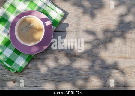 Coffee cup on garden table Stock Photo