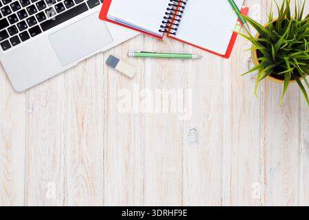 Office desk table with computer, supplies and flower Stock Photo