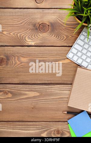 Office desk table with computer, supplies and flower Stock Photo