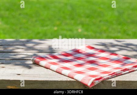 Empty wooden garden table with tablecloth Stock Photo