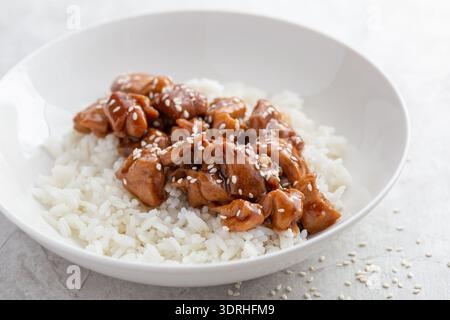 Teriyaki chicken with rice in white bowl,  selective focus Stock Photo