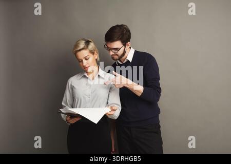 Collection of Two People Reviewing Documents in a Studio Setting During the Day Stock Photo