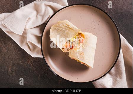 Close up of homemade shawarma with chicken, tomato and cucumber in pita bread top view Stock Photo