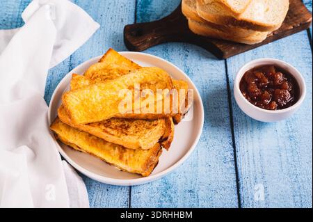 Traditional fried french toasts on white plate on table Stock Photo