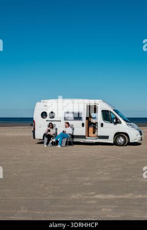 Relaxing by the beach in Denmark with a camper van during a sunny day Stock Photo
