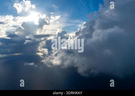 Dramatic sky with sunbeams and clouds seen from an airplane Stock Photo