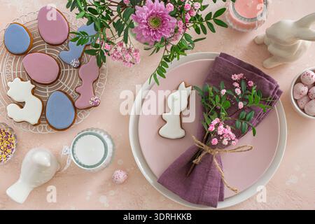 Easter table setting with flowers and icing cookies Stock Photo