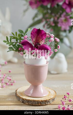 Flowers in eggshell vase. Stock Photo