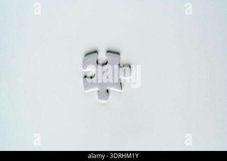 Minimalist concept of a single jigsaw puzzle piece, representing solutions, autism awareness, connection and business strategy Stock Photo