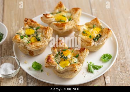 Savory puff pastry cups with egg and cheese Stock Photo