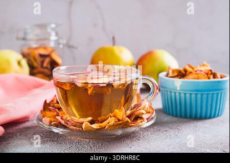 Delicious compote of aromatic dried apples in a cup on the table Stock Photo