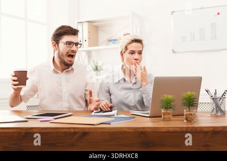Discussion in an Office Setting Between Two Coworkers During a Busy Workday Stock Photo
