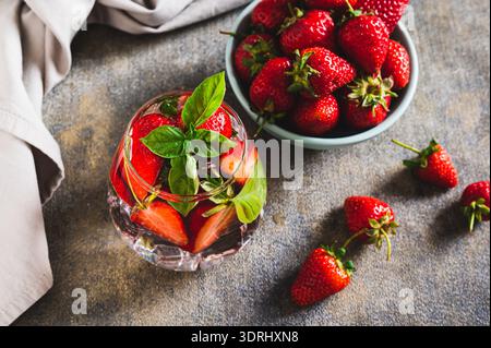 Wellness detox drink with strawberries and basil in glasses on table Stock Photo