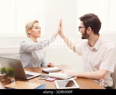 Collage of Two Professionals Interacting in a Workspace During a Project Meeting Stock Photo