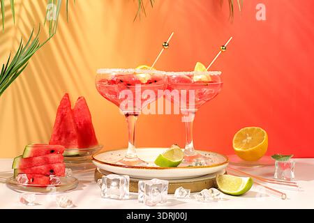 Ice punch with watermelon slices, lemon, mint, ice with tequila, vodka or soda water on elegant background, minimalist concept f Stock Photo
