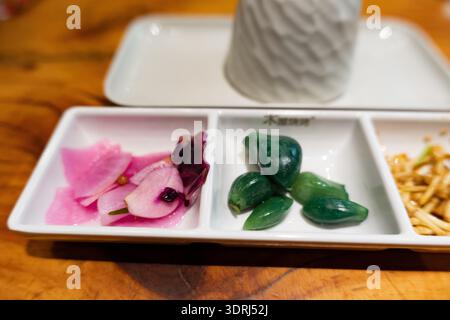 Japanese Pickled Vegetables and Green Wasabi on White Tray with Wooden Table Background Stock Photo