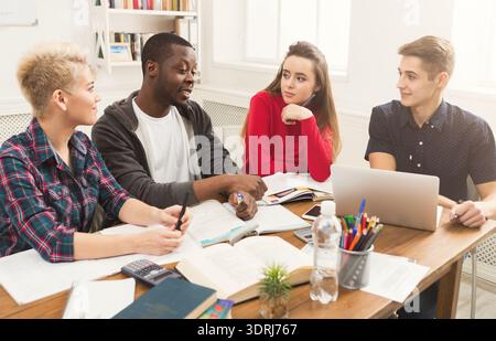 Students Collaborate on a Project During Their Study Session in a Bright Classroom Stock Photo
