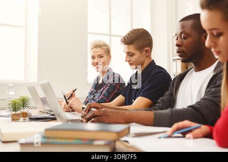 Group of Students Working Together on Laptops in a Study Session at a Classroom Stock Photo