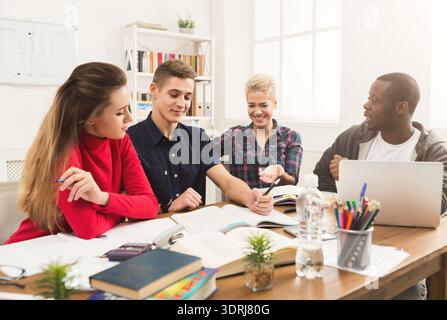 Group of Students Studying and Discussing Together in a Bright Workspace Stock Photo