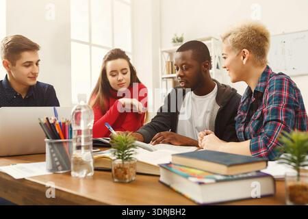 Group of Students Collaborate on a Project During a Study Session in a Well-Lit Room Stock Photo