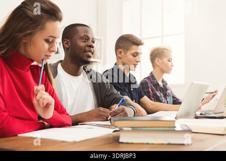 Group of Students Engaging in Study Session in a Bright Classroom Setting Stock Photo