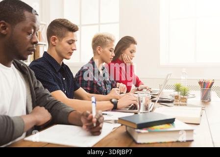 Diverse Group of Students Working Together in a Study Session in a Bright Classroom Stock Photo
