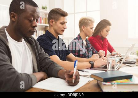 Group of Students Working Together in a Study Session at a Bright Workspace on a Weekend Afternoon Stock Photo
