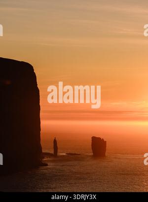 Majestic sunset over Risin og Kellingin in the Faroe Islands with dramatic cliffs Stock Photo