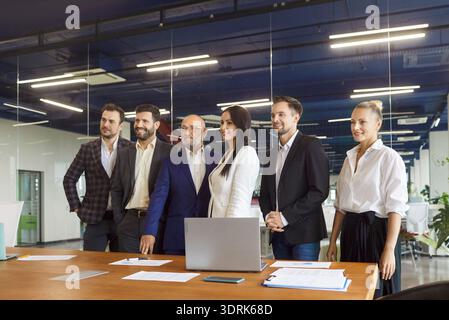 Confident business team portrait at office workplace, happy employees at table Stock Photo