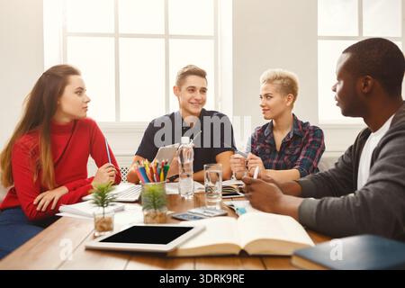 Group of Students Engaged in Discussion and Collaboration in a Study Setting Stock Photo