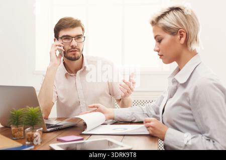 Business Meeting in Office Between Two Colleagues Discussing Project Details and Work Tasks Stock Photo