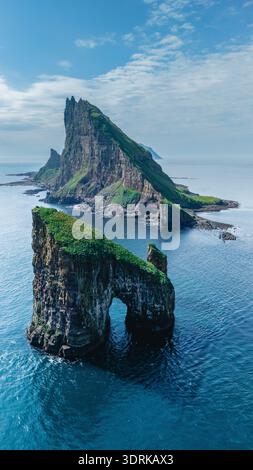 Majestic cliffs and unique rock formations in the Faroe Islands under bright blue skies Stock Photo